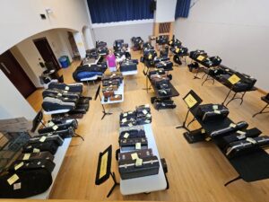 A collection of instruments to be awarded to students, as seen from a bird's eye view in a music classroom.
